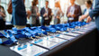 © olgakris - Conference badges with blue lanyards on table, business networking event, professional gathering, name tags, corporate meeting, attendee identification, registration desk, group conversation