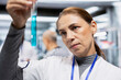© DC Studio - Medic examining test tubes with DNA chemical matter and observing color change during laboratory testing for new medicaments. Biotechnology innovation, clinical research and progress.