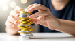 © Throm-Ka - Child stacking shiny chocolate gelt coins into a tower for Hanukkah