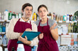 © JackF - Two sellers makes notes on an paper - conducts an inventory in supermarket