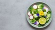 © summer - Colorful flat lay of fresh spring salad featuring crisp cucumber, sliced radish, bright lime, and delicate edible flowers resting on a subtle gray texture ,fresh ,citrus ,flower