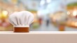 © admin_design - Professional white chef hat resting on clean kitchen countertop culinary uniform essential.