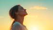 © pariimage - relaxed and happy female figure breathing in deeply against horizon line soft wind movement fitness lifestyle energy clear sky wellness atmosphere