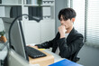 © Kawee - Asian attractive businessman employee working in the office workplace.
