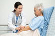 © kanruthai - Asian doctor checking and treat elderly woman patient health in hospital.