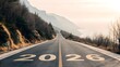 © Mudassir - A wide, empty road leads into the distance with the year 2026 prominently displayed on the asphalt. Surrounding the road is a vast desert landscape under a clear sky.