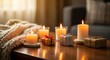 © Amarylle - Warm and cozy winter home interior with burning candles on a wooden table and Christmas gifts. Hygge holiday concept for a festive background.