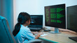 © WMSTUDIO - Young Girl Engaged in Programming and Coding Activities at Home with Multiple Computer Monitors Displaying Code in a Modern Workspace