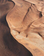 © AmazingAerialAgency - Aerial view of undulating sand dunes with contrasting light and shadow create a mesmerizing pattern of textures and tones, Windhoek, Khomas Region, Namibia.