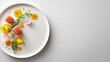 © zuriya - Elegant plate of gourmet food with salmon, vegetables, and artistic presentation on a white surface.