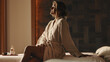 © Jacob Lund - Woman relaxing in a spa while wearing a robe, focusing on skincare and tranquility