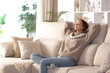 © PheelingsMedia - Woman relaxing on a couch in winter at home
