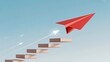 © shakilhossain - Red paper airplane ascending stairs towards success