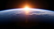 © XT Dabro - Epic view of Earth from space showing the bright sun rising or setting over the horizon with the thin blue atmosphere and scattered clouds