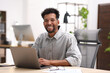 © New Africa - Man working on laptop at table in office