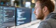 © เด็กชาย นุ่มนิ่ม - maintenance technical repair optimization concept. Focused programmer working on multiple screens displaying code.