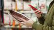 © Pavel - Woman scanning dry pet food with smartphone in supermarket. Modern customer checking product information and ingredients using mobile app, AI assistant. Smart shopping Digital retail Conscious choice