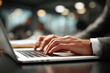 © angelmaxmixam - Male hands typing on a modern laptop keyboard. A professional businessman works diligently in a corporate office environment, showcasing focused productivity and technology use.