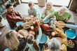 © deagreez - Funny wholesome family thanksgiving feast where generations gather to celebrate togetherness around a roasted turkey at a cozy home table with friends