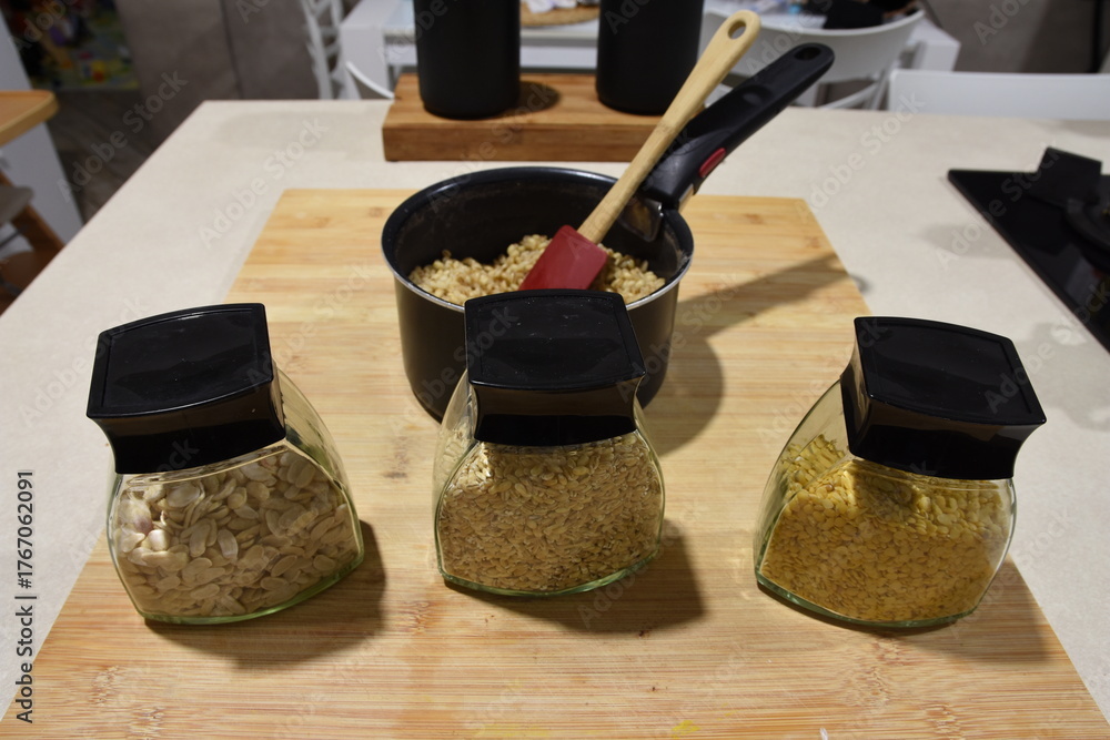 various types of cereals ready to be cooked and a pot containing ...