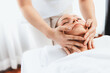 © InfiniteFlow - Caucasian woman enjoying relaxing anti-stress head massage and pampering facial beauty skin recreation leisure in dayspa modern light ambient at luxury resort or hotel spa salon. Quiescent