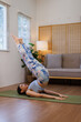 © David - Headstand, doing yoga exercise. Beautiful young asian woman or japanese girls with slim body type is indoors.
