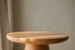 © Ruslana - close up of modern wooden round table in minimalist living room setting in warm tones. minimalist interior design. aesthetic background
