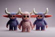 © stefanholm - Three cute, whimsical designer toys with furry textures and horns, presented as a collectible set in a studio product shot, appealing to pop culture enthusiasts.