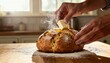 © DhanaStudio - Freshly baked round bread with melting butter on wooden kitchen table