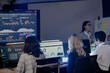 © ultramansk - Future mission control synergy Diverse team leverages AI predictive insights interactive screens guide complex operations leader directs augmented human AI team achieve optimal results faster.