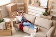 © Pixel-Shot - Young woman lying in rented apartment on moving day