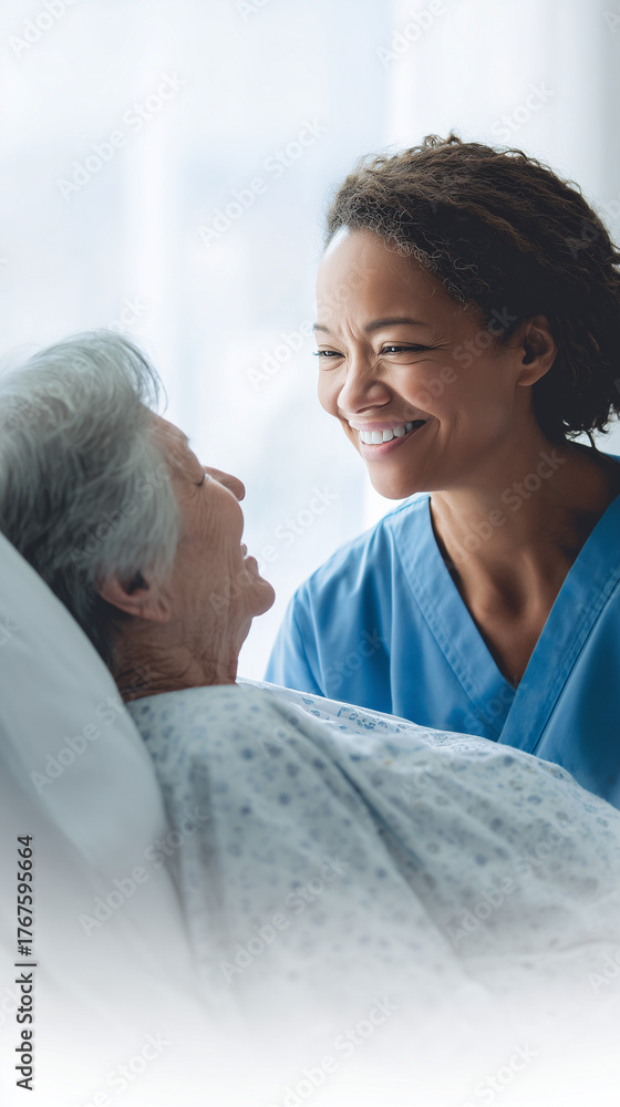 Nurse smiling while caring for an elderly patient in the hospital bed ...