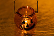 © Taisiia Hosh - Top view of glass pumpkin candle holder with burning candle