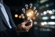 © SyedAbdulRehman - Businessman holding glowing lightbulb and question mark with copy space for creative thinking idea and problem solving concept.