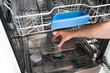 © brizmaker - Repairing a broken dishwasher in a modern kitchen setup by a skilled professional