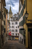 St Peter Church clock tower framed by historic buildings in Zurich, Switzerland