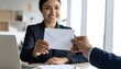 © aidliskndr - Businesswoman receiving a letter or document in office