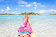 © Matteo Colombo - Woman with legs up in the blue lagoon of Tikehau, Polynesia