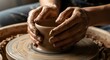 © Julia - Potter hands shaping wet clay on a wheel, creating a ceramic pot. Hobby and craft workshop for handmade ceramics.