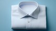 © irawan - Crisp, freshly laundered white collared garment is neatly folded against a soft blue backdrop