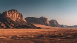 Towering sandstone formations dominate a vast, arid desert landscape during sunset or sunrise
