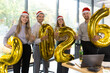 © ty - Business people are celebrating holiday in modern office drinking champagne and having fun in coworking. Merry Christmas and Happy New Year 2026