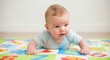 © photoplotnikov - Caucasian baby on colorful play mat engaged in tummy time indoors