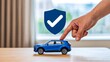 © Sajjad - Hand touching blue car with protection shield and check mark symbol for vehicle insurance safety