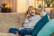 © Andrii Iemelianenko - Young teenager girl calling phone mother at home, speaking eagerly and pausing to listen with patient nods. Blonde child kid on sofa shares daily tales, conversation with friendly details and laughter