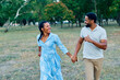 © Lumos sp - Happy active young black  couple having fun walking running holding hands and bonding in park or nature outdoors