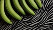 © russcom - Fresh green bananas arranged on a stylish zebra-pattern fabric background