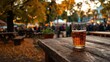 © faki - A glass of amber ale sits on a rustic wooden table at dusk