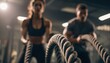 © Andrii - Couple Training Together With Battle Ropes For Arms And Cardio At The Gym: A Crossfit Workout For Fitness Enthusiasts.