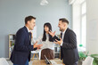 © Studio Romantic - In an office, coworkers face a heated conflict and argument, rising with tension and stress, while a colleague attempts mediation to calm the dispute. Two coworkers argue as mediator intervenes
